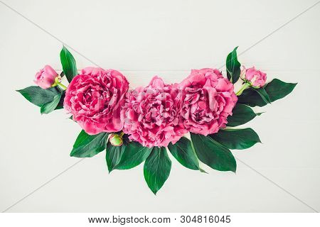 Flower Border Composition Made Of Bright Pink Buds Peony Bouquet On A White Wooden Background. Flora