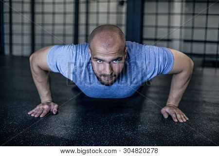 Sport. Young Athletic Man Doing Push-ups. Muscular And Strong Guy Exercising. Dressed In A Sports Un