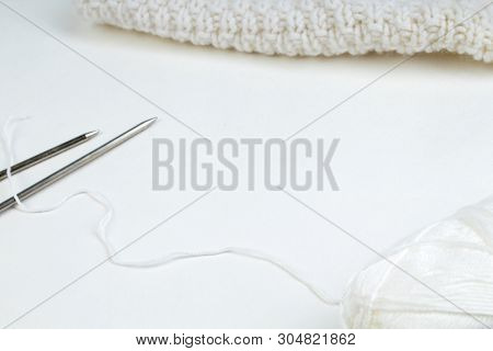 Pair Of Knitting Needles Isolated Over White. Sweater Or Scarf White Crocheted Fabric Texture. Knitt