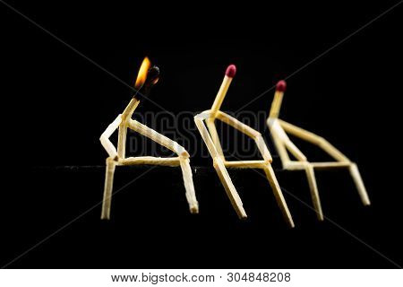 Three Characters Made Of Matchsticks Sad And Sitting In The Dark, One Away From The Other. One Of Th