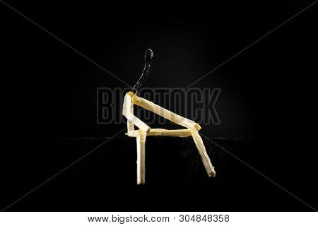 Image Of A Man Made Of Matchstick. Small And Depressive In The Dark, Erased And Losing The Flame. Co