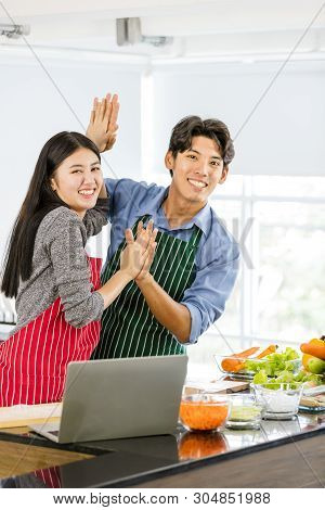 Couple In Apron Make Salad Rolls Together..