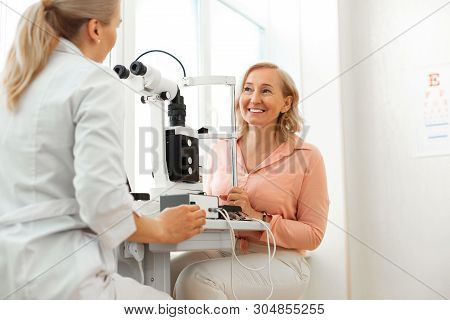Smiling Short-haired Patient With Wide Smile Having Pleasant Conversation