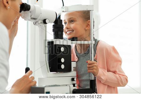 Cute Young Patient With Blue Eyes Calmly Enduring Procedure