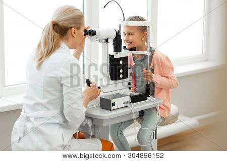 Tranquil Cute Girl Placing Chin On Supporting Stand