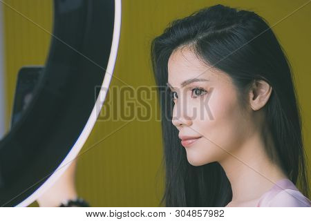 Beautiful Asian Woman Model  Take A Selfie Photo In Front Of Studio Light.