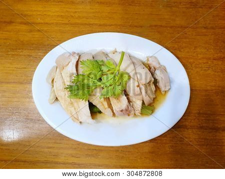 Chinese Food Style, Top View Of Steamed Chicken Topped With Coriander In White Plate On Wooden Table