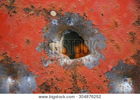 Hole From The Canister Of The Twelfth Caliber Of A Hunting Smooth-bore Gun In A Steel Plate 3 Mm Thi
