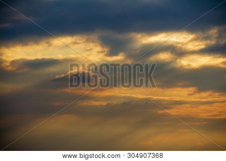 Evening Weather, Golden Cloud And Gray Sky With Sun Light Are Shone Through The Clouds Look Feel Goo