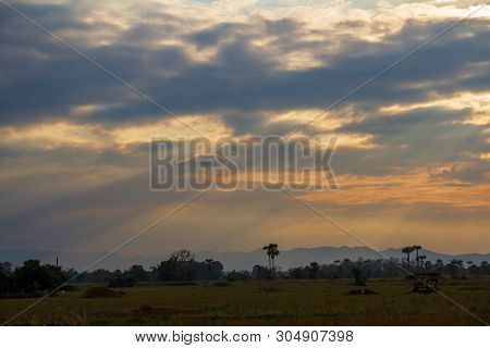 Evening Weather In The Field, Golden Cloud And Sky With Sun Light Are Shone Through The Clouds Look 