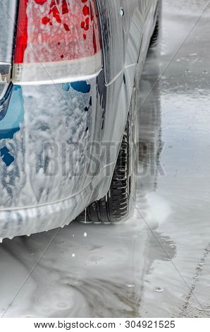 Car Covered With White Foam On Car Wash Station
