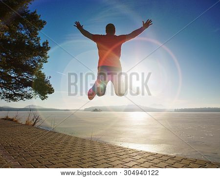 Tall Man Jamping By Sea On The Beach. Powerful Runner Training Outdoor In Cold Spring Morning. Hot S