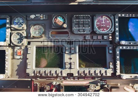 Black Control Panel In A Helicopter Cockpit.