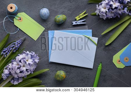 Top View Of Paper Cards With Copy-space, Blue Hyacinth Flowers And Easter Eggs On Dark Textured  Bac