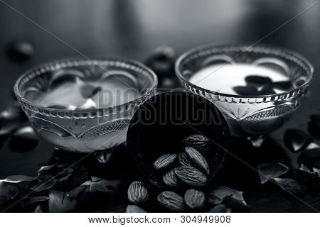 Milk And Almond Face Pack On Black Colored Shiny Surface I.e. Raw Milk,almond,honey Well Mixed In A