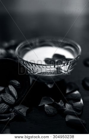 Milk And Almond Face Pack On Black Colored Shiny Surface I.e. Raw Milk,almond,honey Well Mixed In A