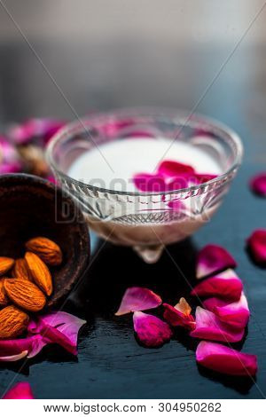 Milk And Almond Face Pack On Black Colored Shiny Surface I.e. Raw Milk,almond,honey Well Mixed In A