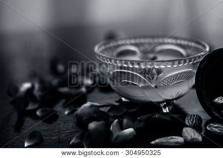 Milk And Almond Face Pack On Black Colored Shiny Surface I.e. Raw Milk,almond,honey Well Mixed In A