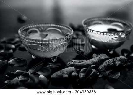 Milk Face Pack On Black Shiny Surface Consisting Of Raw Milk,turmeric Or Haldi And Badam In A Glass