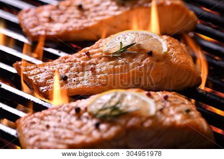 Grilled Salmon Fish With Various Vegetables On The Flaming Grill