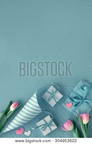 Blue Background With Pink Tulips, Stripy Wrapping Paper And Wrapped Gift Boxes, Copy-space