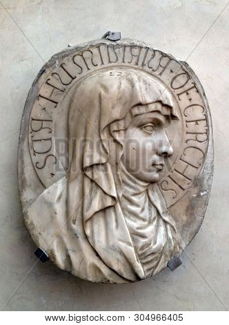 FLORENCE, ITALY - JANUARY 10, 2019: Portrait of the blessed Umiliana de Cerchi, bas relief in white marble, Basilica di Santa Croce (Basilica of the Holy Cross) in Florence, Italy