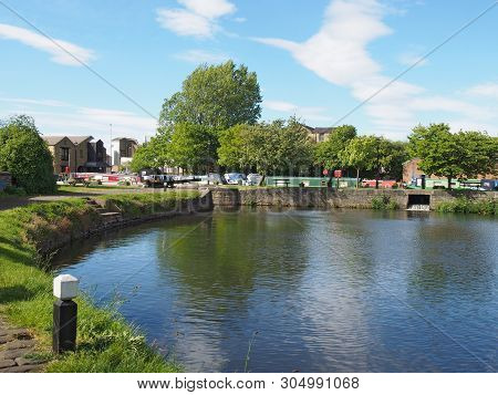 A View Of The Lock Entrance To Brighouse Basin With Moored Houseboats On The Calder And Hebble Navig