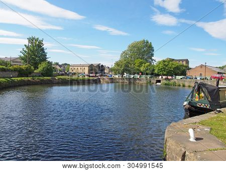 A View Of The Lock Entrance To Brighouse Basin With Moored Houseboats On The Calder And Hebble Navig
