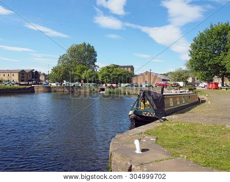 Moored Houseboats And Barges At Brighouse Basin On The Calder And Hebble Navigation Canal In Calderd