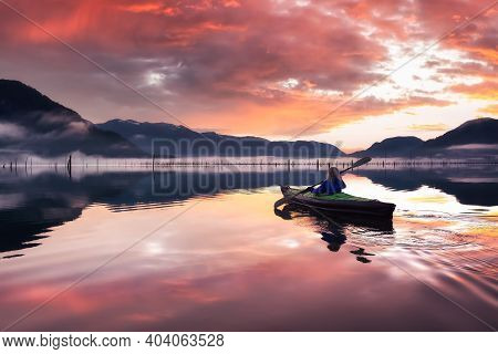 Adventurous Girl Kayaking On An Infatable Kayak In A Beautiful Lake. Colorful Peaceful Sunrise Art R