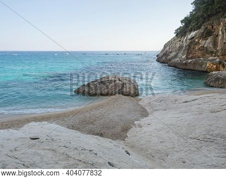 A View Of Empty Cala Goloritze Beach With White Pebbles Limestone Rock And Turquoise Blue Water. Fam