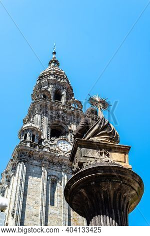 Sculpture Of Apostle St. James Against The Tower Of Cathedral Of Santiago On Blue Sky