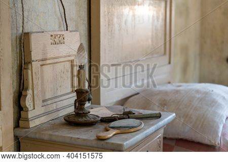 Italy, 20 January 2021. Almost Burnt Candle On A Bedside Table In A Bedroom, In An Abandoned House. 