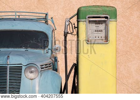 Oingt, France - March 12, 2014: Old And Vintage Gas Pump With A Citroen Car In France