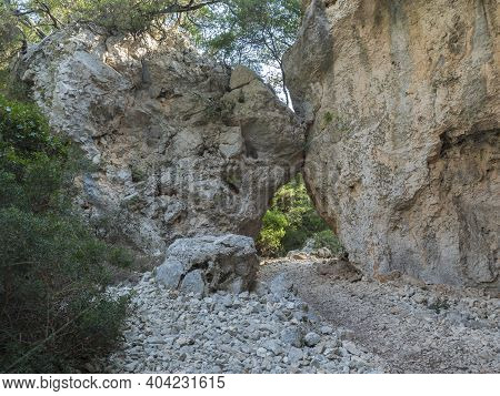 A View Of Rocky Hiking Trail To Cala Goloritze Beach, Path Between Two Limestone Rocks. Famous Trave