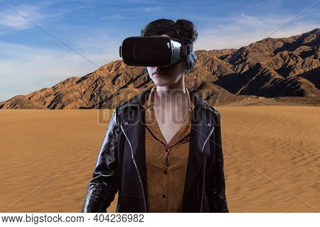 Woman Wearing A Virtual Reality Headset In A Simulated Hiking Experience Through The Desert.  Vr Tou