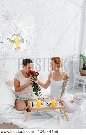 View Of Beautiful Lesbian Couple Together In Bed At Home Background