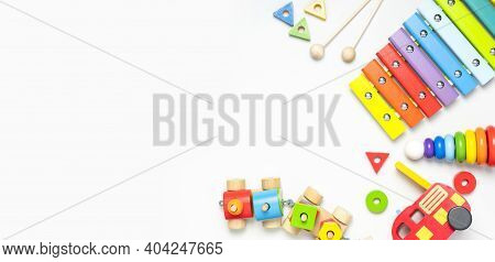 Children's Toys Made Of Natural Wood On White Background. Multi-colored Pyramid, Train, Constructor,
