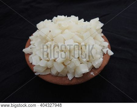 Small Size Sliced Or Cut Piece Of Dry Copra With Cup And Bowl Isolated On Black Background