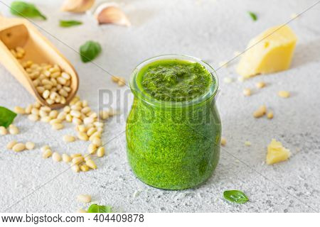 Green Pesto In A Glass Jar Made From Fresh Basil Leaves, Pine Nuts, Parmesan, Garlic And Olive Olia 