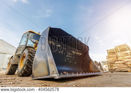 Low Angle Shoot Of A Small Tractor Or Escavator. Industrial Concept.