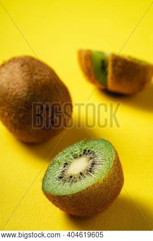 Kiwi Fruits Half Sliced On Yellow Background, Angle View