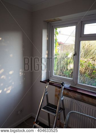 A Room Being Decorated Showing Partly Papered Walls And A Stepladder