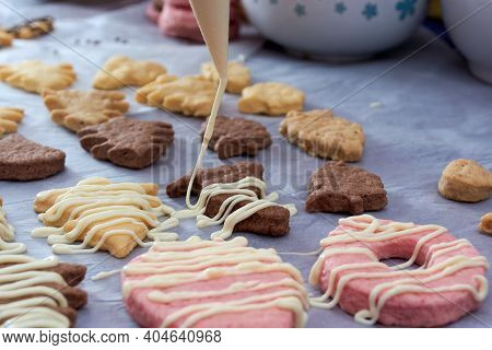 Pouring Chocolate On Just Baked Christmas Cookies