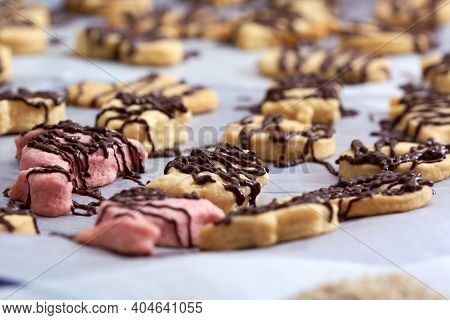 Pouring Chocolate On Just Baked Christmas Cookies