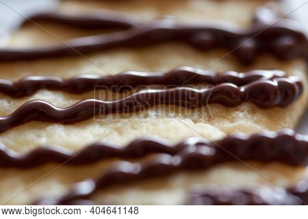 Pouring chocolate on just baked christmas cookies