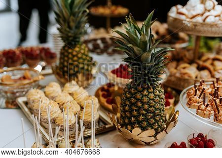 Closeup Of A Wedding Candybar With Cakes And Fruits