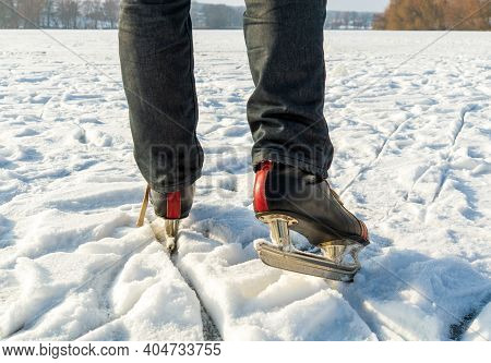 Skates On Legs Close Up. Ice Skating On A Rural Pond In Winter