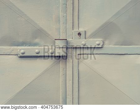 Rusty Metal Latch With Lock Housing Of Cargo Garage Or Warehouse. Corrosion Stains On Metal Sheet Ga