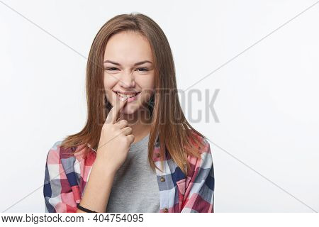 Playful Girl Inventing Some Prank Biting Her Finger